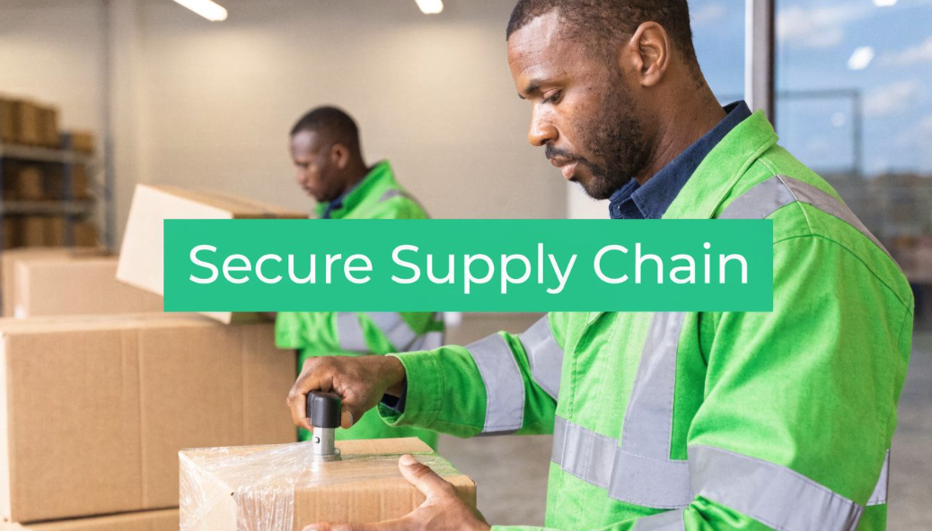 Two warehouse workers in high-visibility jackets handling boxes in a secure supply chain setting